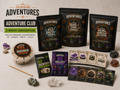 Three-month Adventure Club subscription showing three Excavating Adventures kits with a dig tray, discovery cards, Gemling pack, specimen cards, rocks, and crystals.
